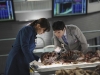 BONES:  Brennan (Emily Deschanel, L) and Jeffersonian intern Vincent Nigel-Murray (Ryan Cartwright, R) examine the remains of the latest victim of sniper-on-the-loose Jacob Broadsky in "The Hole in the Heart" episode of BONES airing Thursday, May 12 (9:00-10:00 PM ET/PT) on FOX.  ©2011 Fox Broadcasting Co.  Cr:  Michael Becker/FOX