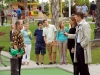 BONES: Brennan (Emily Deschanel, C) and Booth (David Boreanaz, R) question Sammy Tucker (guest star Carlos Alazraqui, L) at a mini-golf tournament to try to piece together the murder of the sport's superstar, in the "The Putter In The Rough" episode of BONES airing Thursday, April 16 (8:00-9:00 PM ET/PT) on FOX. Â©2015 Fox Broadcasting Co. Cr: Ray Mickshaw/FOX