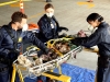 BONES:  Brennan (Emily Deschanel, C), Hodgins (T.J. Thyne, L) and Cam (Tamara Taylor, R) examine the dead body of a professional mini-golfer found in a parking structure, in the "The Putter In The Rough" episode of BONES airing Thursday, April 16 (8:00-9:00 PM ET/PT) on FOX. Â©2015 Fox Broadcasting Co. Cr: Adam Taylor/FOX