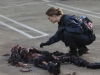 BONES:  Brennan (Emily Deschanel) examines a body at a crime scene in the BONES episode "The Bond in the Boot" airing Thursday, Sept. 24 (8:00-9:00 PM ET/PT) on FOX.  ©2009 Fox Broadcasting Co.  Cr:  Greg Gayne/FOX